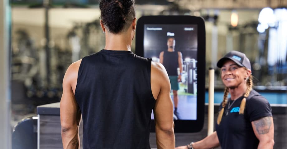 eos member being shown how to use smart strength equipment